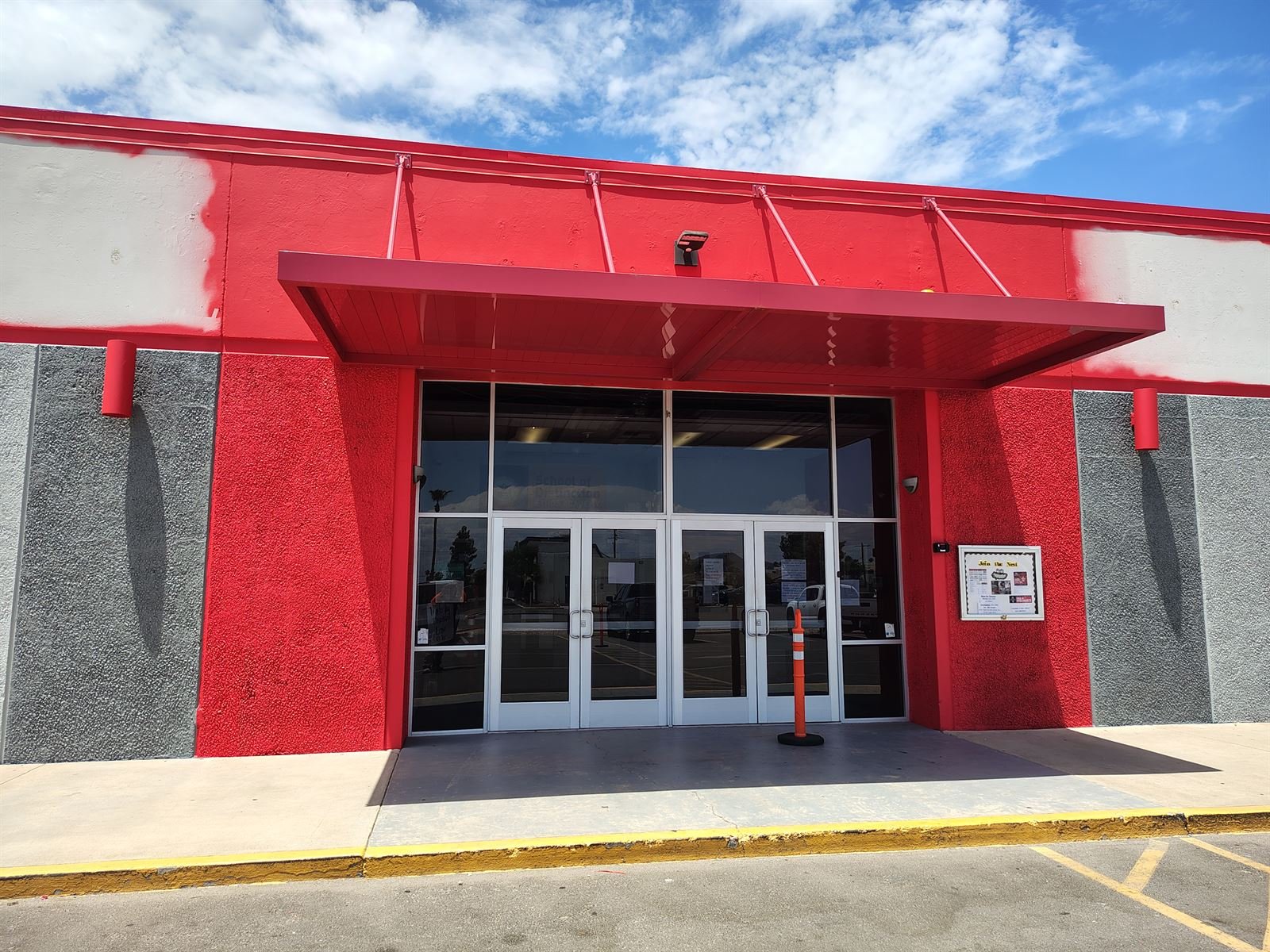 Commercial storefront entrance repainted red and gray