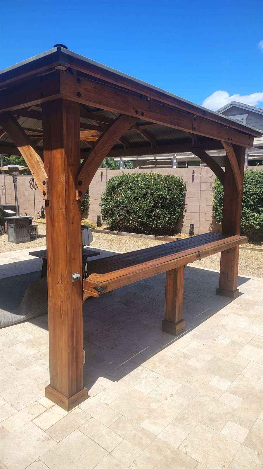 Restored and re-stained cedar pergola against a clear Arizona sky