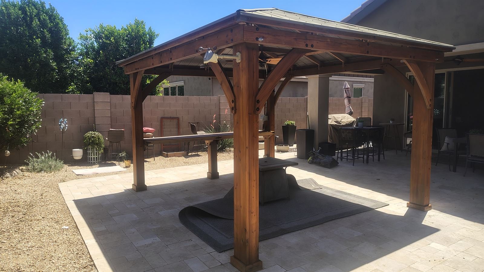 Cedar pergola restored and re-stained over a travertine patio